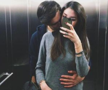 romantic couple poses for selfies