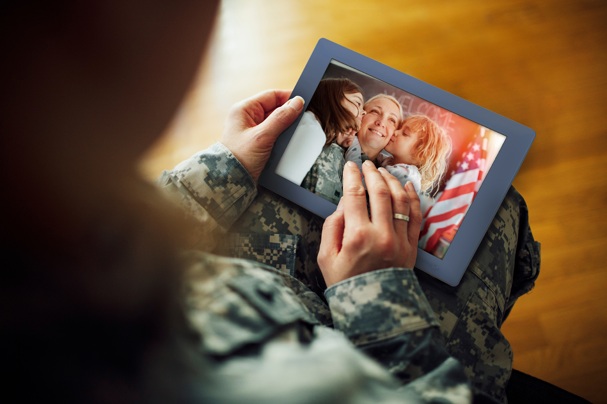 Military Mom looking at photos of her children on her Nixplay frame.