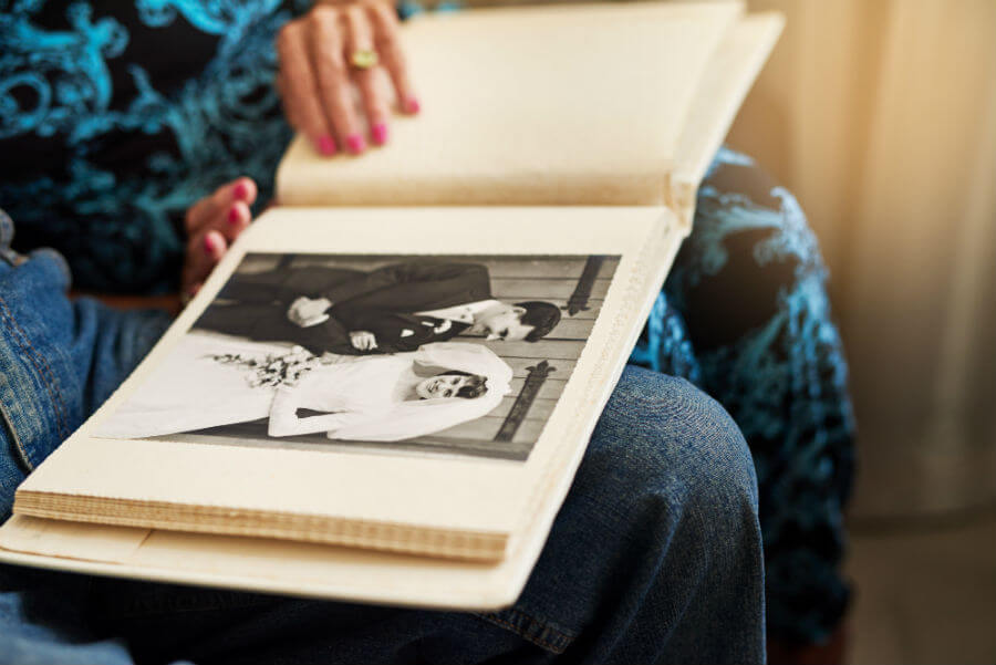 elderly couple looking at an old photo album